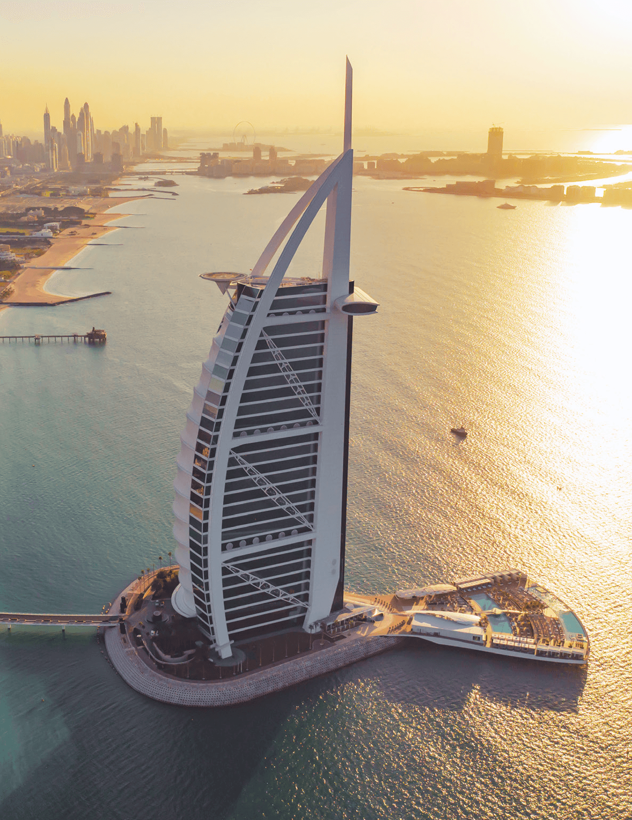 Aerial view of Dubai coastline and iconic architecture at golden hour